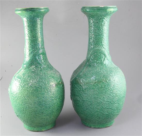 A pair of Chinese green glazed dragon vases, late 19th/early 20th century, height 44.5cm, one neck repaired